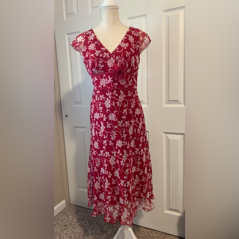 Red and white floral dress. Zips on the side and ties around the back.